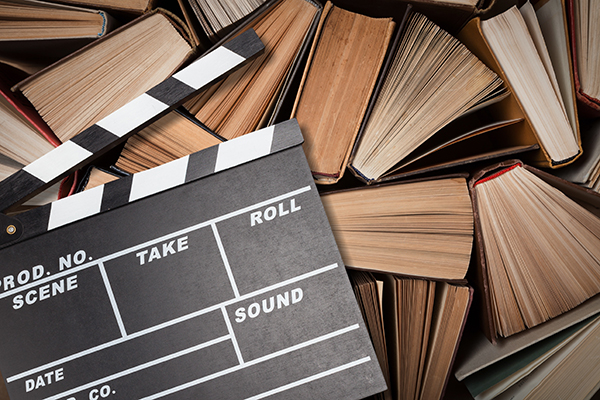 Image of movie clapperboard on top of books