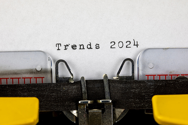 A close up of paper in an old typewriter that reads "Trends 2024"